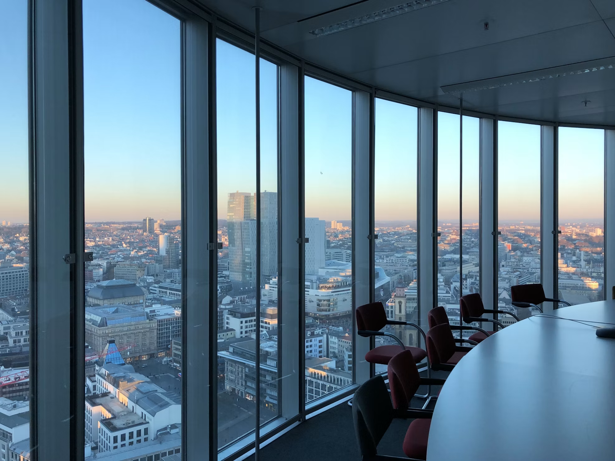 High-floor meeting room with floor-to-ceiling windows over the city